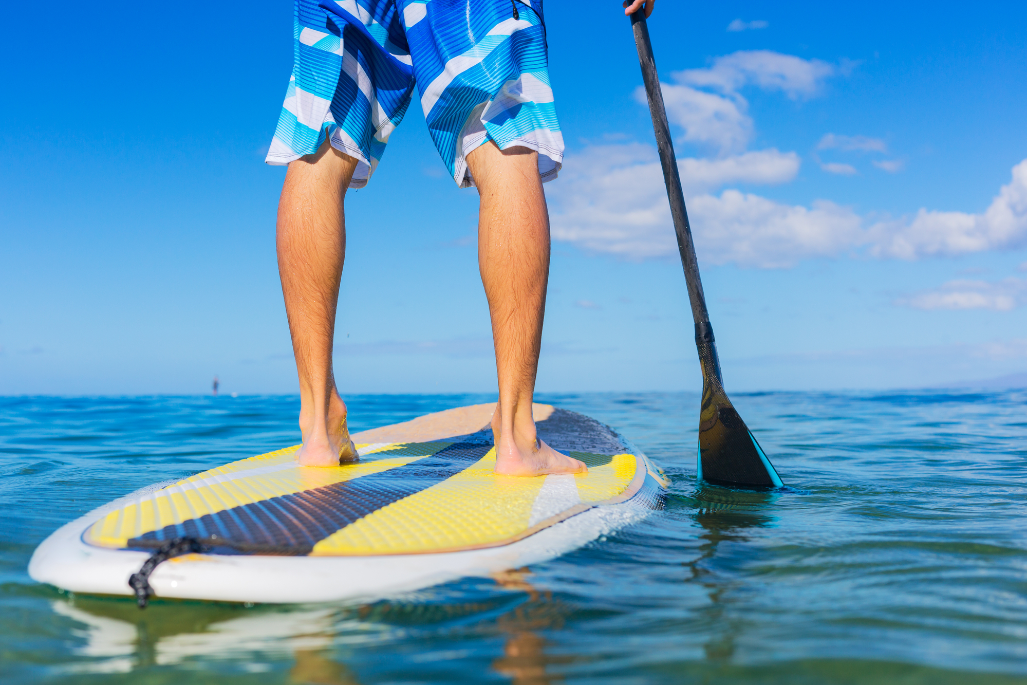 man on paddle board in ocean